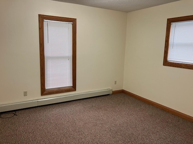 903 2nd St, Princeton, MN 55371 - unfurnished room featuring a baseboard radiator, carpet, and baseboards
