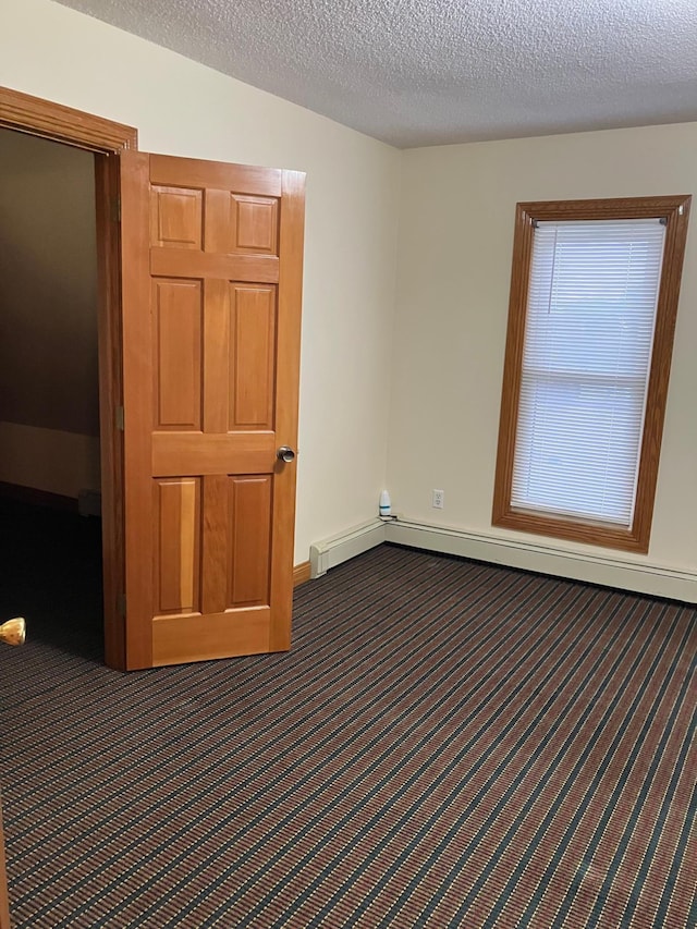 903 2nd St, Princeton, MN 55371 - carpeted empty room featuring baseboards, a textured ceiling, and baseboard heating