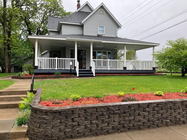 903 2nd St, Princeton, MN 55371 - farmhouse-style home with a shingled roof, a front lawn, a porch, and a chimney