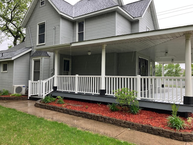 903 2nd St, Princeton, MN 55371 - view of home's exterior featuring a porch, a cooling unit, and a shingled roof