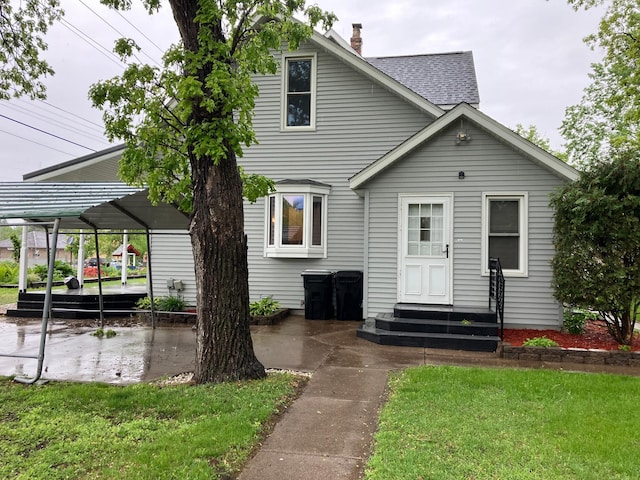 903 2nd St, Princeton, MN 55371 - view of front of property featuring entry steps, a patio area, a chimney, a front lawn, and a shingled roof