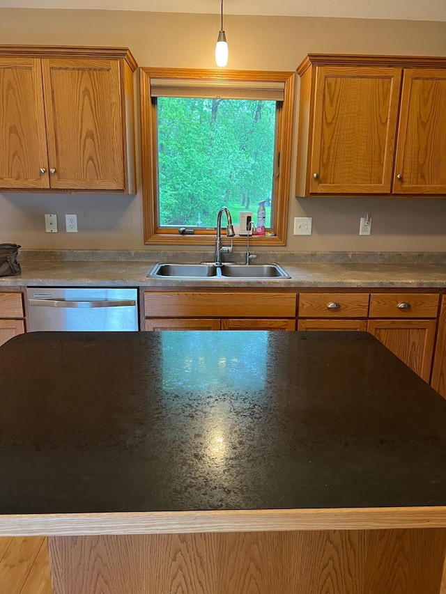 205 Darling Pl, Alexandria, MN 56308 - kitchen featuring a sink, stainless steel dishwasher, brown cabinets, and decorative light fixtures