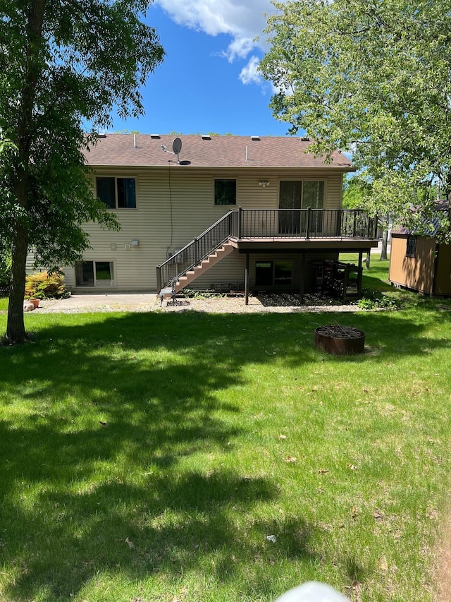 205 Darling Pl, Alexandria, MN 56308 - back of house featuring stairway, a deck, a lawn, and a patio