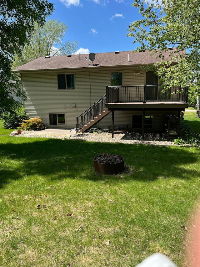 205 Darling Pl, Alexandria, MN 56308 - rear view of house featuring stairs, a deck, a yard, and an outdoor fire pit