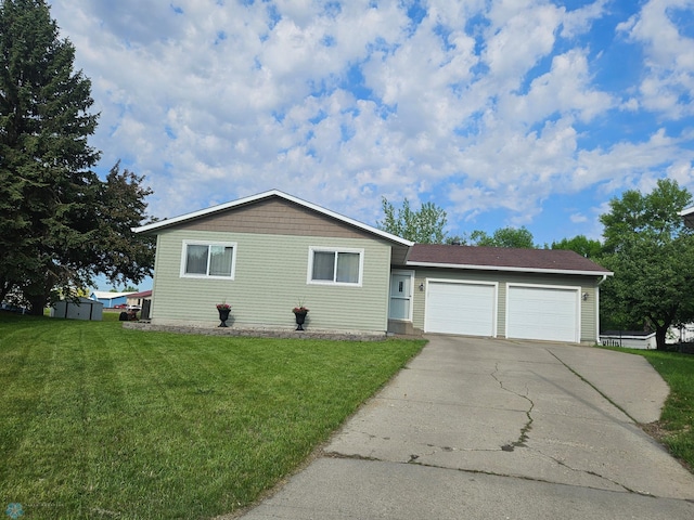 2904 17th Ave S, Moorhead, MN 56560 - view of front of home with an attached garage, a front yard, and driveway