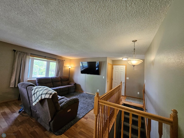 2904 17th Ave S, Moorhead, MN 56560 - living room featuring light wood-type flooring, a textured ceiling, and baseboards