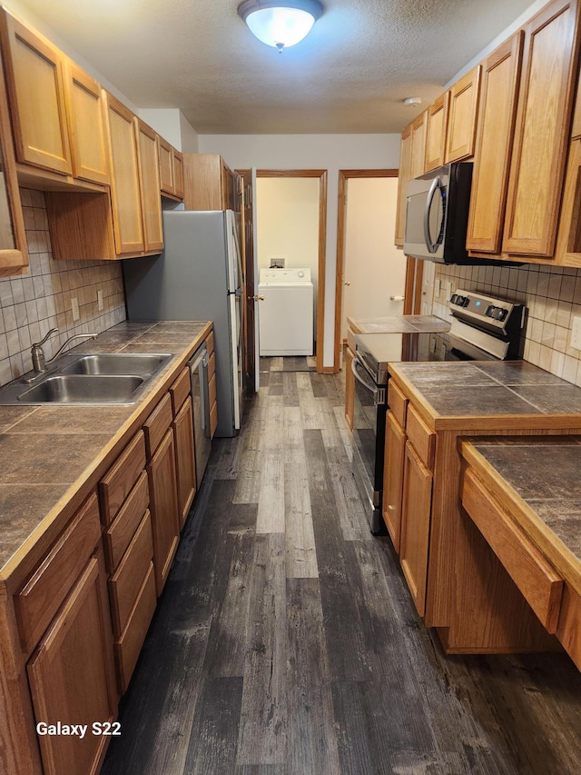 6454 Appaloosa Ave S, Forest Lake, MN 55025 - kitchen featuring range with electric stovetop, washer / dryer, dark wood-type flooring, tasteful backsplash, and a sink