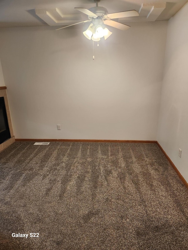 6454 Appaloosa Ave S, Forest Lake, MN 55025 - carpeted empty room featuring baseboards, a ceiling fan, and a tiled fireplace
