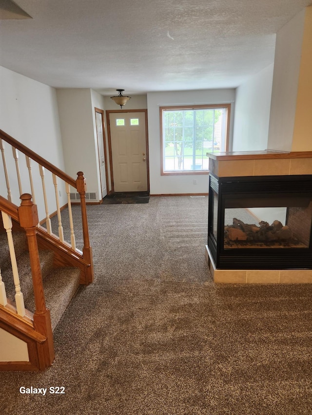 6454 Appaloosa Ave S, Forest Lake, MN 55025 - carpeted foyer featuring stairs, baseboards, and a multi sided fireplace