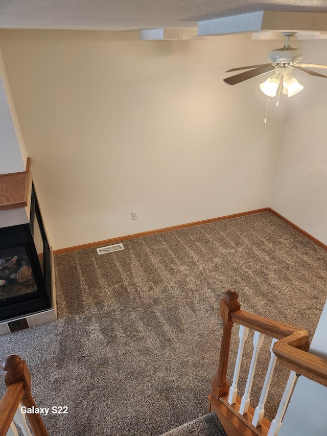 6454 Appaloosa Ave S, Forest Lake, MN 55025 - unfurnished living room with ceiling fan, carpet, a fireplace, and baseboards