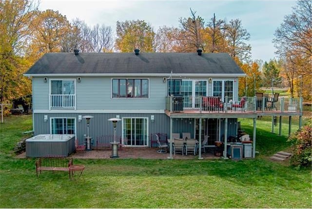 28320 State Highway 65, Pengilly, MN 55775 - back of house with a hot tub, a patio area, a wooden deck, and a yard
