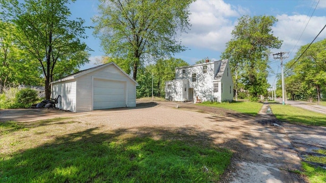 401 Julii St, Willmar, MN 56201 - view of grassy yard with a detached garage, an outdoor structure, and driveway