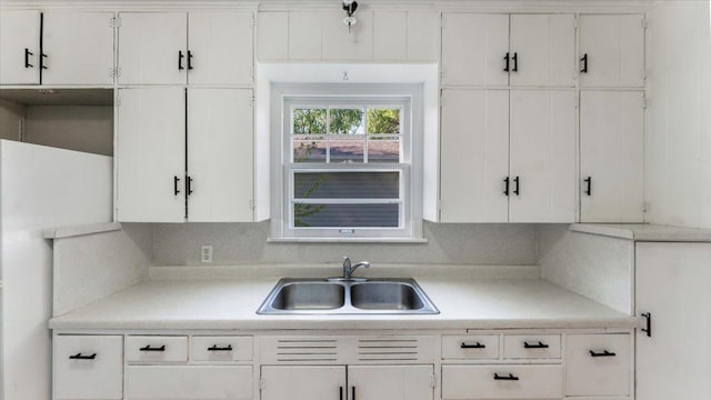 401 Julii St, Willmar, MN 56201 - kitchen with a sink, light countertops, and white cabinets