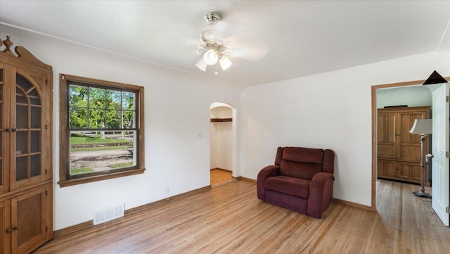 401 Julii St, Willmar, MN 56201 - sitting room featuring light wood-style flooring, a ceiling fan, and arched walkways