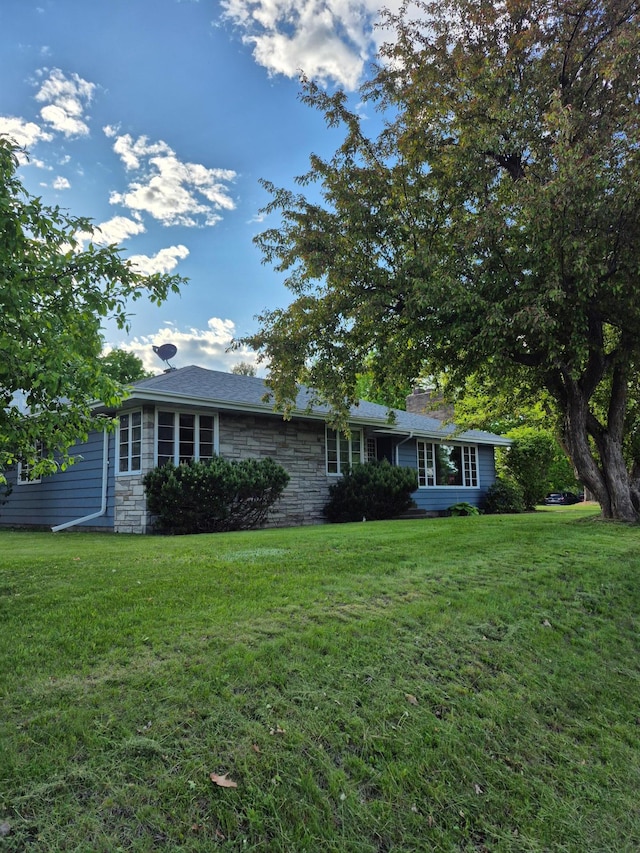 227 Summit Ave, Grantsburg, WI 54840 - ranch-style house with a front lawn, stone siding, and a chimney