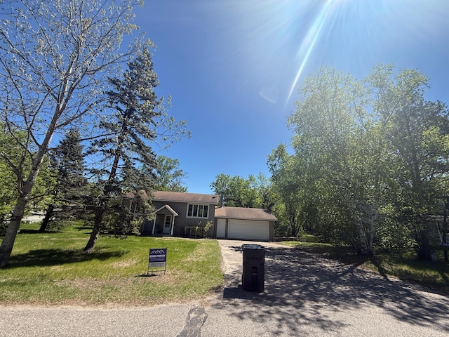 144 Circle Pines Dr NW, Bemidji, MN 56601 - tri-level home featuring driveway, a front yard, and an attached garage