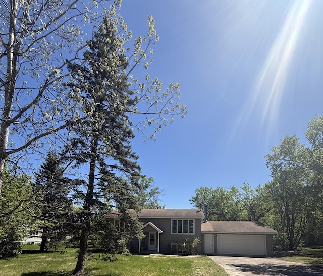 144 Circle Pines Dr NW, Bemidji, MN 56601 - tri-level home featuring driveway, a garage, and a front lawn
