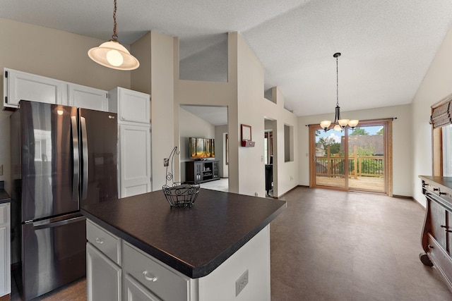 7150 Upper 157th St W, Apple Valley, MN 55124 - kitchen featuring freestanding refrigerator, vaulted ceiling, dark countertops, a chandelier, and white cabinetry