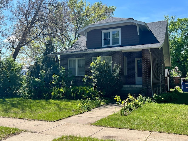 623 4th St, Madison, MN 56256 - view of front of property featuring brick siding, a front yard, and roof with shingles