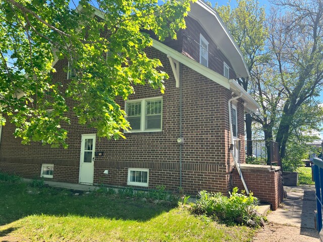 623 4th St, Madison, MN 56256 - view of home's exterior featuring brick siding