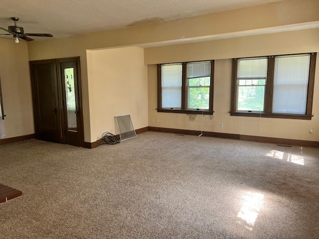623 4th St, Madison, MN 56256 - carpeted spare room featuring a ceiling fan, baseboards, and a textured ceiling