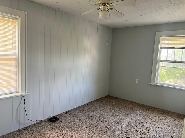 623 4th St, Madison, MN 56256 - carpeted empty room with a ceiling fan and wooden walls