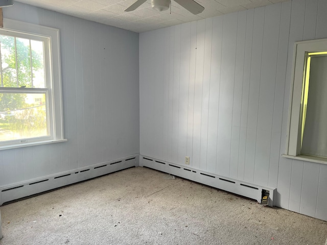 623 4th St, Madison, MN 56256 - unfurnished room featuring carpet flooring, a ceiling fan, a baseboard radiator, and wooden walls