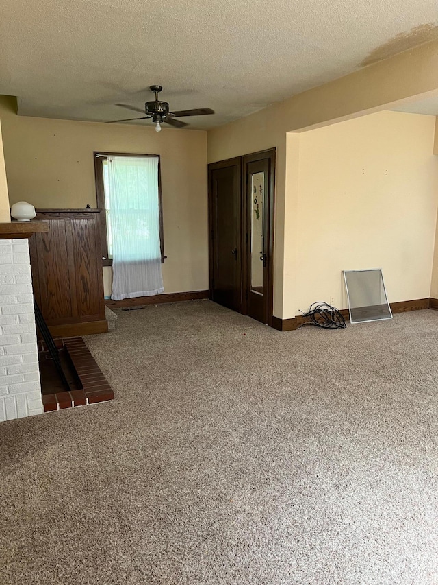 623 4th St, Madison, MN 56256 - unfurnished living room with a ceiling fan, carpet, a textured ceiling, and baseboards