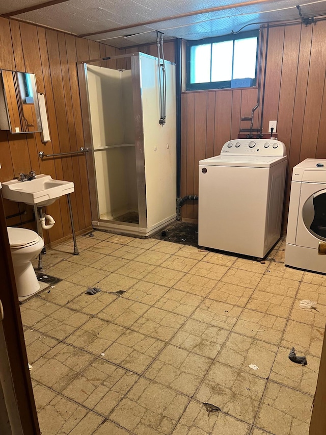623 4th St, Madison, MN 56256 - laundry area with wooden walls and washer and clothes dryer