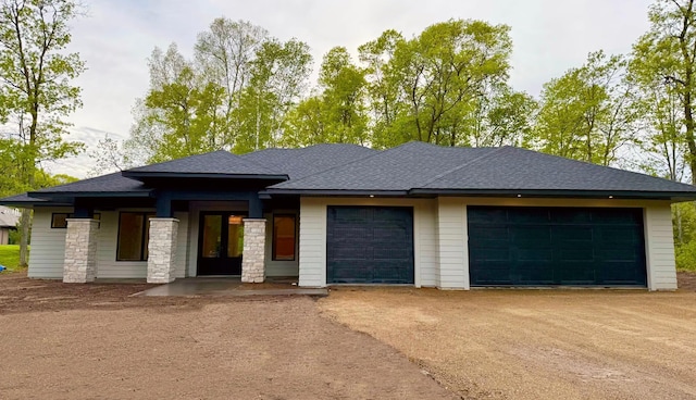 36211 Talon Trl, Crosslake, MN 56442 - prairie-style house featuring an attached garage, driveway, roof with shingles, and stone siding