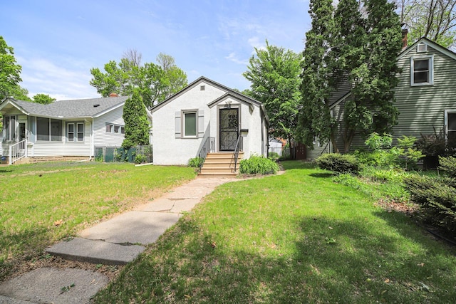 4104 Upton Ave N, Minneapolis, MN 55412 - view of front of property with a front yard, a sunroom, and a chimney