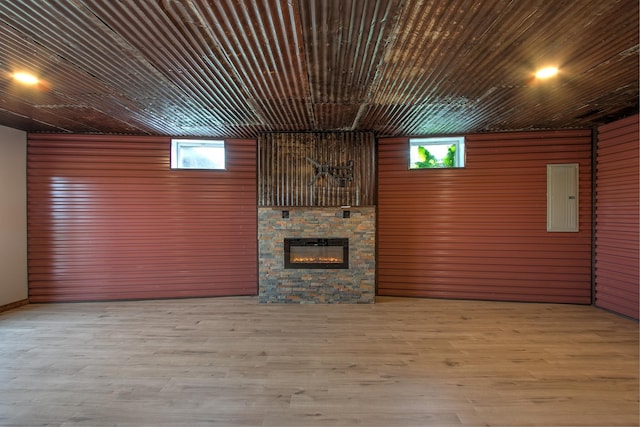 2200 405th Ave NW, Braham, MN 55006 - unfurnished living room with electric panel, a stone fireplace, and wood finished floors