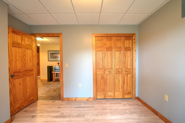 2200 405th Ave NW, Braham, MN 55006 - unfurnished bedroom featuring a drop ceiling, light wood-style flooring, and a closet