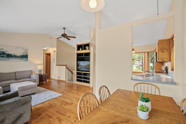 2572 91st Ln NE, Blaine, MN 55449 - dining area featuring a ceiling fan, wood finished floors, and high vaulted ceiling