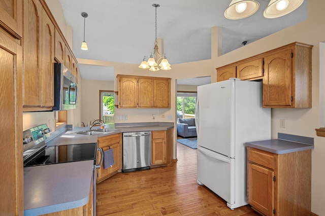2572 91st Ln NE, Blaine, MN 55449 - kitchen featuring appliances with stainless steel finishes, a sink, a chandelier, light wood-type flooring, and pendant lighting
