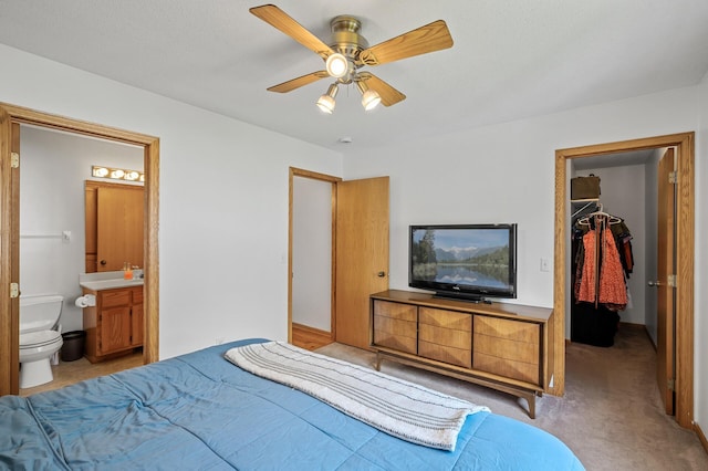 2572 91st Ln NE, Blaine, MN 55449 - bedroom featuring a walk in closet, light colored carpet, a closet, ensuite bathroom, and a ceiling fan