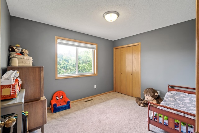 2572 91st Ln NE, Blaine, MN 55449 - carpeted bedroom with a textured ceiling, a closet, and baseboards
