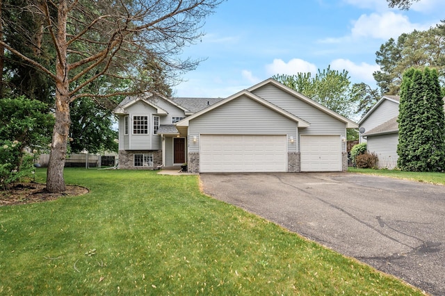 2572 91st Ln NE, Blaine, MN 55449 - split level home featuring asphalt driveway, an attached garage, brick siding, and a front yard