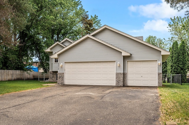 2572 91st Ln NE, Blaine, MN 55449 - view of front of house featuring brick siding, driveway, and an attached garage