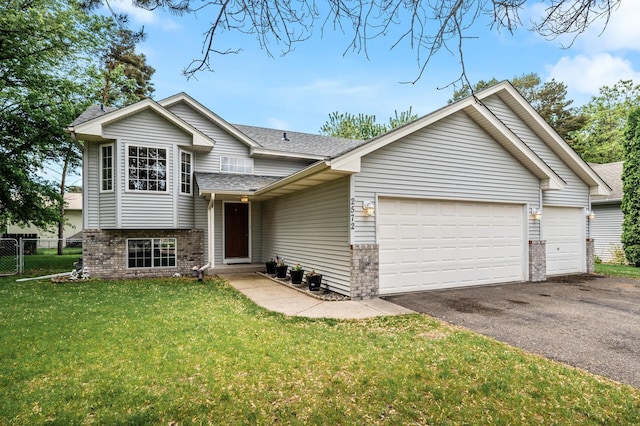 2572 91st Ln NE, Blaine, MN 55449 - split level home with brick siding, driveway, a garage, and a shingled roof