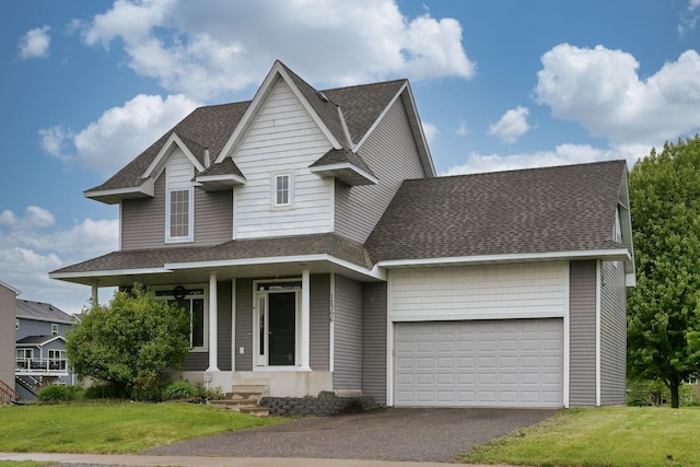 12396 67th St NE, Otsego, MN 55330 - view of front of home with roof with shingles, driveway, a garage, and a front yard
