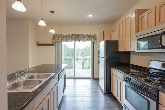 12396 67th St NE, Otsego, MN 55330 - kitchen with stainless steel appliances, a sink, dark countertops, dark wood-style flooring, and recessed lighting