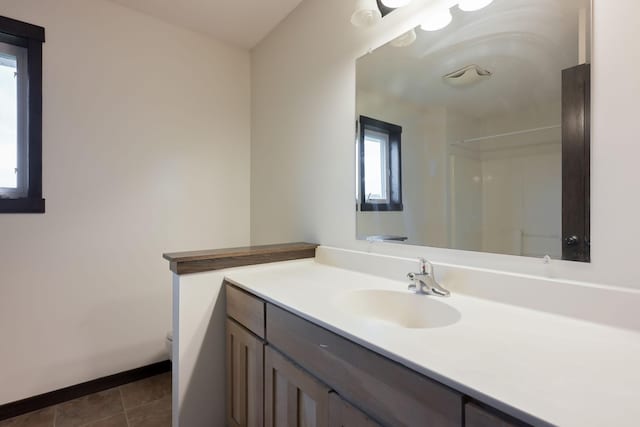 12396 67th St NE, Otsego, MN 55330 - full bath with vanity, toilet, a shower, baseboards, and tile patterned flooring