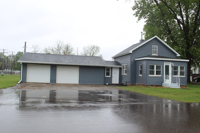 202 Main St W, Morristown, MN 55052 - view of front facade featuring a garage and a shingled roof
