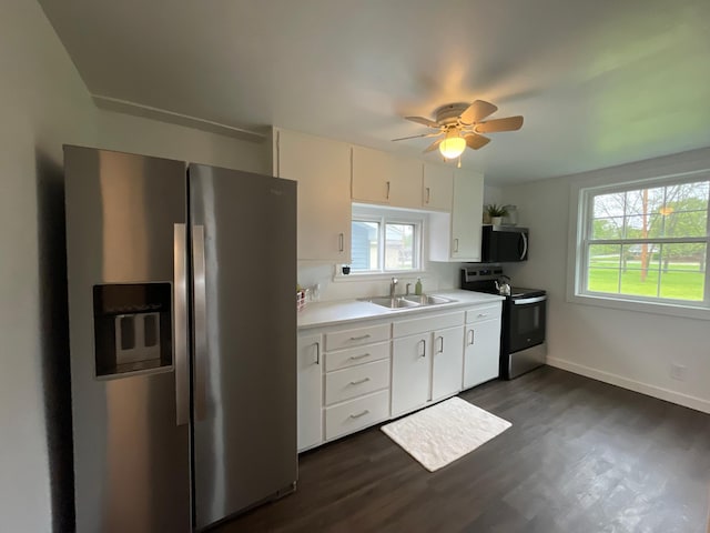 202 Main St W, Morristown, MN 55052 - kitchen featuring appliances with stainless steel finishes, a sink, light countertops, a ceiling fan, and dark wood-style floors