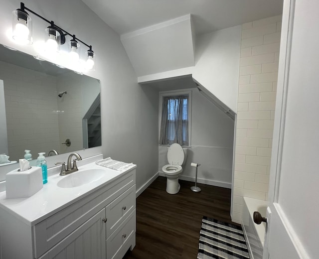 202 Main St W, Morristown, MN 55052 - full bath with vanity, toilet, wood finished floors, baseboards, and shower / washtub combination