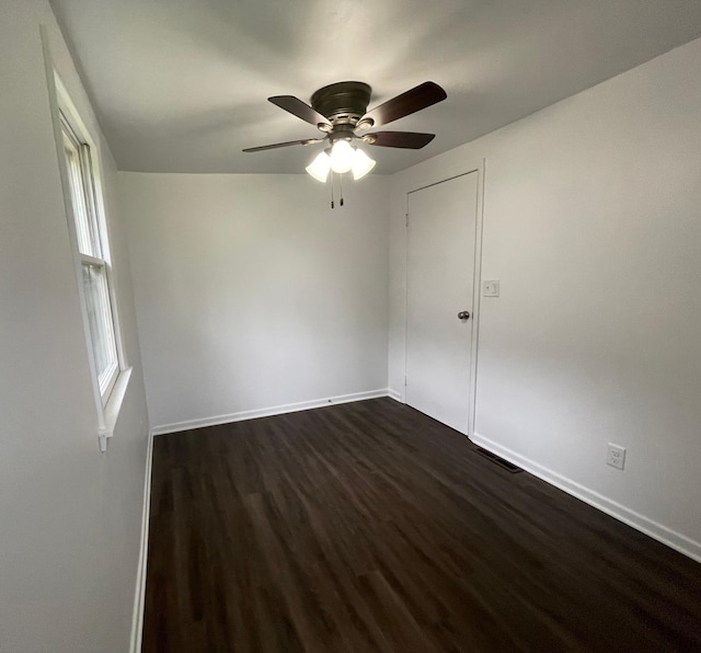 202 Main St W, Morristown, MN 55052 - unfurnished room featuring dark wood-style flooring, baseboards, and ceiling fan