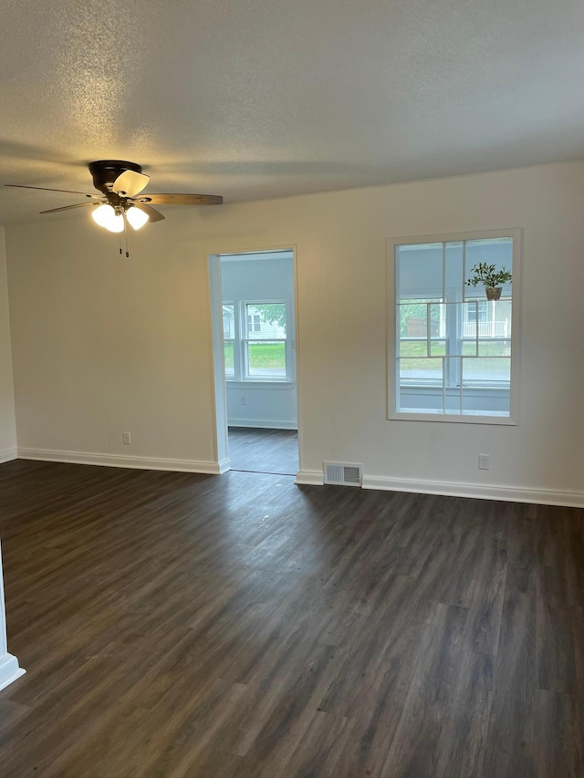 202 Main St W, Morristown, MN 55052 - spare room with dark wood-style floors, ceiling fan, a textured ceiling, and baseboards