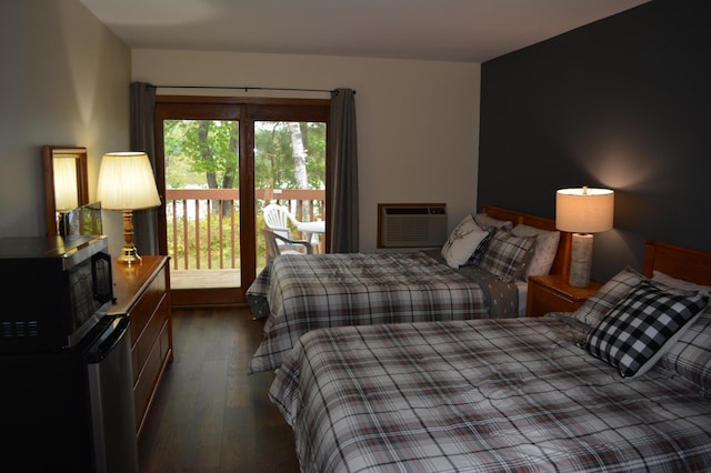 15326 Birch Point Rd, Lenroot Twp, WI 54843 - bedroom featuring dark wood-type flooring and a wall unit AC