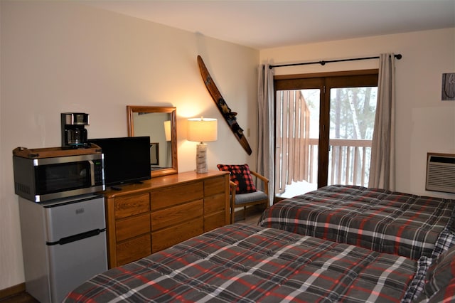 15326 Birch Point Rd, Lenroot Twp, WI 54843 - bedroom with refrigerator, access to outside, and an AC wall unit
